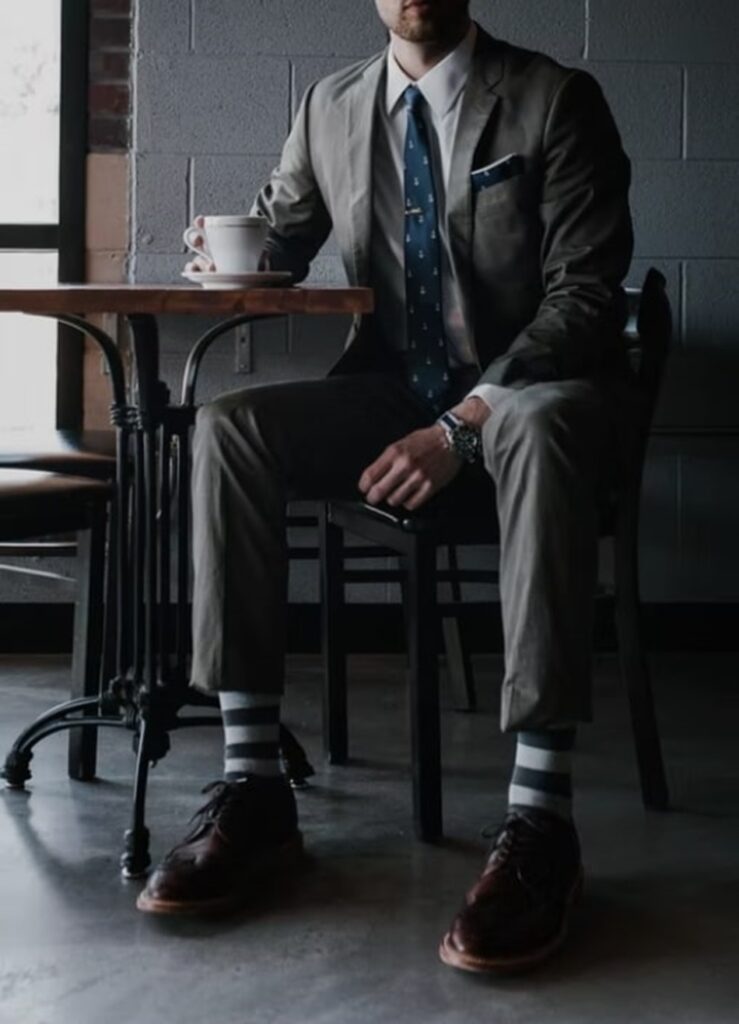 Michael Van Eaton related image featuring a person in a suit beside indoor furniture